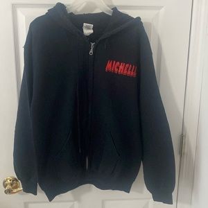 Black zip pocket sweatshirt. Michelle on front Comic book men graphic on back. M
